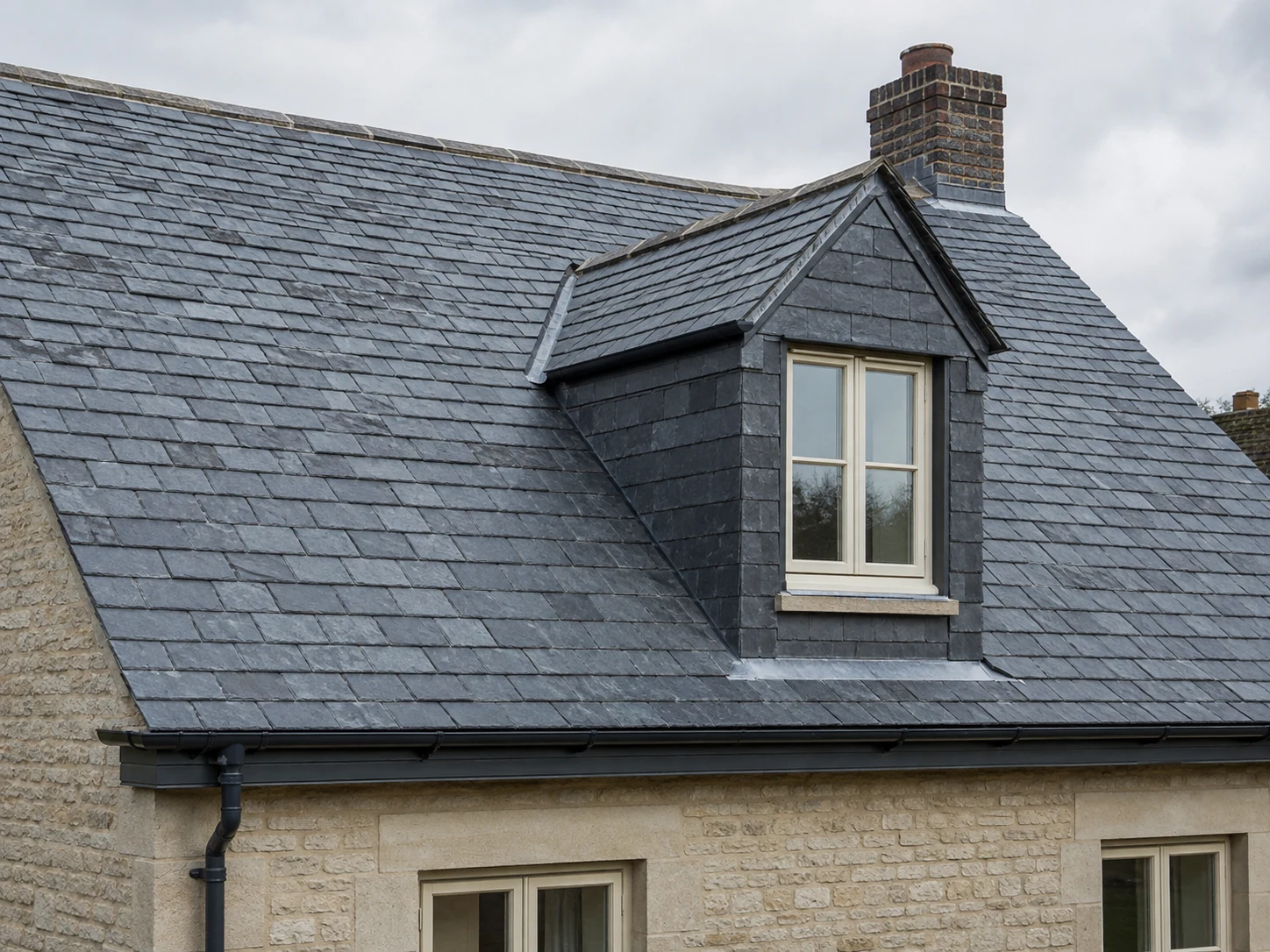 Example slate pitched roof with a dormer window.